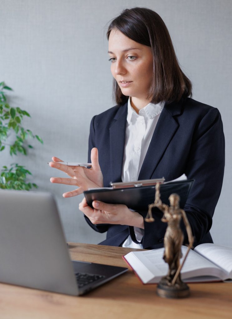 woman lawyer or lawyer in her office conducts an online consultation or webinar on legal services